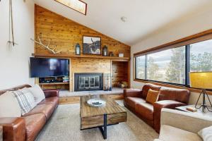 a living room with a couch and a fireplace at Wapiti Townhouse 3 in Fraser