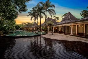 a resort with a pool and a building at Ayurvedagram Bali - Wellness & Retreat Resort in Ubud