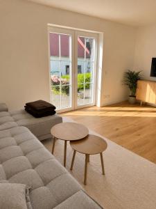a living room with a couch and two tables at Landidylle in Wenden Schönau in Wenden