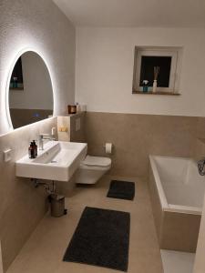 a bathroom with a sink and a toilet and a tub at Landidylle in Wenden Schönau in Wenden +11 photos
