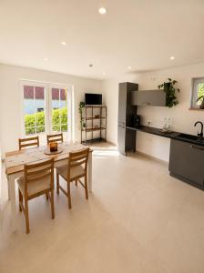 a kitchen and dining room with a table and chairs at Landidylle in Wenden Schönau in Wenden