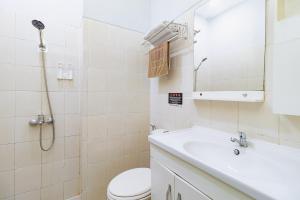 a bathroom with a toilet and a sink and a shower at RedDoorz Plus at Suba Hotel Tanjung Duren in Jakarta +17 photos