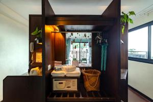 a room with a shelf with towels and a mirror at Vacation Village Phra Nang Inn - SHA Extra Plus in Ao Nang Beach