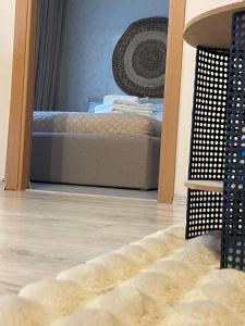 a reflection of a bed in a mirror at Maya Apartment in Cluj-Napoca +73 photos