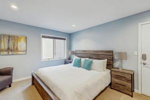 a bedroom with a bed and a chair and a window at Beaver Creek West 22 in Avon +45 photos