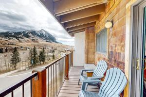two chairs on a balcony with a view of a mountain at Mountain Delight in Crested Butte