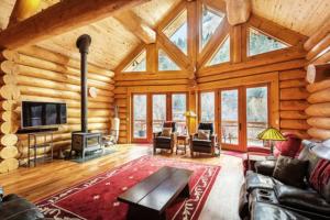a living room with a fireplace in a log cabin at South Fork Sanctuary in South Fork