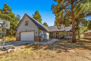 a house with a garage and a basketball hoop at The Getaway on Garnet in Pagosa Springs