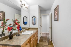 a bathroom with a sink and a mirror at The Getaway on Garnet in Pagosa Springs +56 photos