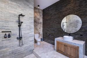 a bathroom with a sink and a mirror at Villa Nesanur - Comfortable & Spacious Beachside Sanur in Sanur