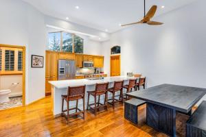 a kitchen with a large island with bar stools at Snowy Peak Sanctuary in Vail