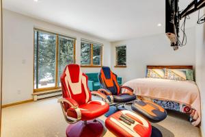 a bedroom with two chairs and a bed at Snowy Peak Sanctuary in Vail