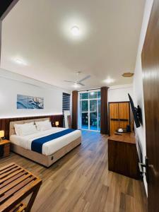 a large bedroom with a bed and a wooden floor at Heda Retreat in Aluthgama