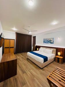 a bedroom with a large bed and wooden floors at Heda Retreat in Aluthgama +6 photos