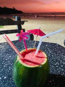 a drink sitting on a table next to the beach at Heda Retreat in Aluthgama