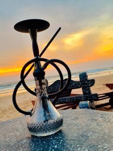 a vase sitting on a table next to the beach at Heda Retreat in Aluthgama