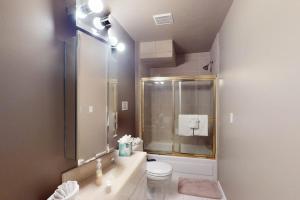 a bathroom with a shower and a toilet and a sink at Timberline Chalet in Breckenridge +42 photos