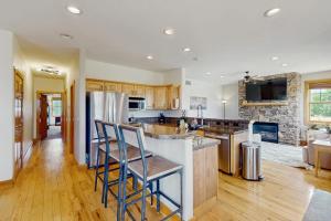a large kitchen with wooden floors and a counter top at Mountain Sky Retreat in Granby