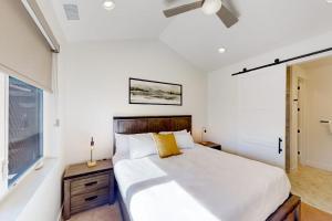 a bedroom with a large white bed and a window at Yampa Valley Escape in Steamboat Springs +72 photos