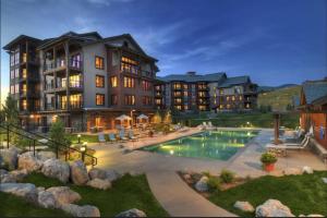 a large apartment building with a swimming pool at Yampa Valley Escape in Steamboat Springs