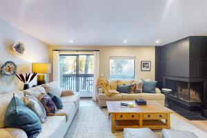 a living room with two couches and a fireplace at SunSong Escape in Fraser