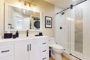 a bathroom with a toilet and a sink and a shower at SunSong Escape in Fraser +44 photos