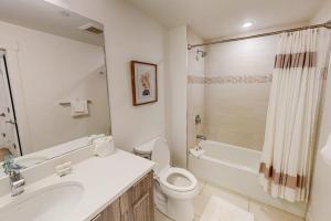 a bathroom with a toilet and a sink and a shower at Blue River Dream in Silverthorne +16 photos