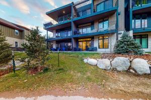 a large apartment building with a fence in front of it at Blue River Dream in Silverthorne