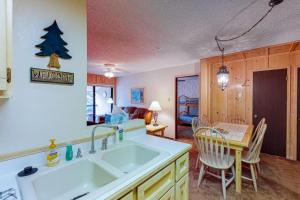 a kitchen and dining room with a christmas tree on the wall at Angelhaus #300 in Durango Mountain Resort