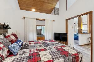 a bedroom with a king sized bed and a television at Mountainside 049 in Granby +74 photos