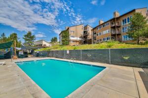 an empty swimming pool in front of a building at Mountainside 049 in Granby