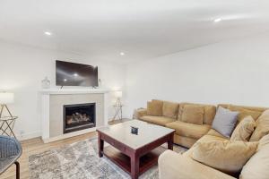 a living room with a couch and a fireplace at Library House in Durango