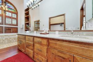 a bathroom with a double sink and a large mirror at Wayne Creek Residence in Avon +110 photos