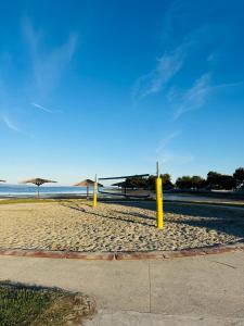 a beach with yellow poles in the sand at Holiday House Zaton in Zaton