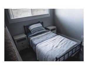 a small bedroom with a bed and two night stands at Pleasant View House in Freeland