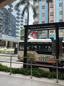 a bus stop with a bus on a city street at Resorts World Eighty One Newport Boulevard Near Airport T2 and T3 in Manila