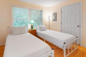 two beds in a room with a window at Post Road Charmer in Moody +51 photos