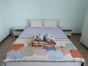 a bed with two pairs of slippers on it at Chinese home in Masis