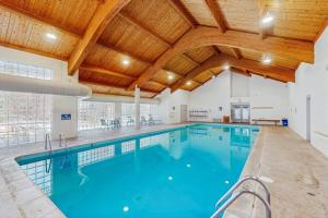a large indoor pool with a wooden ceiling at Quicksilver 1654 in Keystone