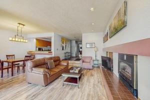 a living room with a couch and a fireplace at Quicksilver 1654 in Keystone