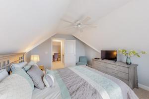 a bedroom with a large bed with a ceiling fan at Cape Arundel House in Kennebunk +59 photos