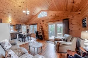 a living room with a couch and chairs in a cabin at The Pinecone in Winthrop +38 photos