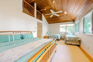 a bedroom with two beds and a ceiling fan at The Lodge at Seapoint Beach in Kittery