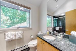 a bathroom with a sink and a toilet and a window at The Lodge at Seapoint Beach in Kittery +87 photos