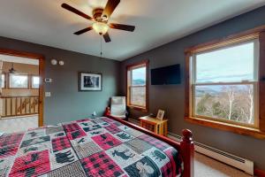 a bedroom with a bed and a ceiling fan at Thunder Ridge Lodge in Newry