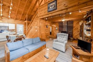 a living room with a blue couch and a table at Lake View Cottage in Leeds