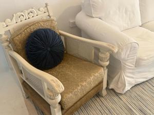a pillow sitting on a chair next to a bed at Little Mykonos right here in Stanthorpe! in Stanthorpe