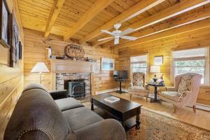 a living room with a couch and a fireplace at Moose Cabin in Bridgton
