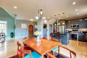 a large kitchen with a wooden table and chairs at Stone Creek Retreat in Cape Neddick