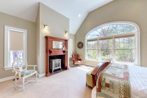 a bedroom with a bed and a fireplace at Stone Creek Retreat in Cape Neddick